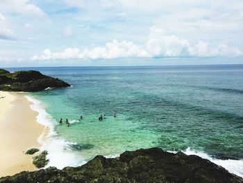 High angle view of people swimming in sea