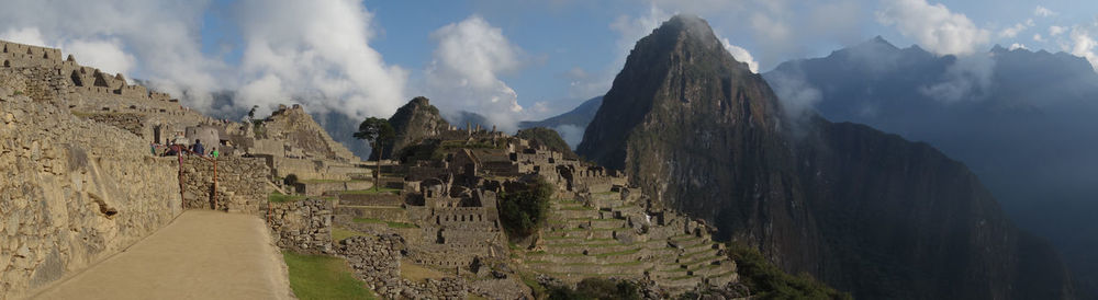 Panoramic view of ruins against cloudy sky