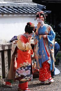 Geisha women smiling outdoors