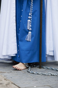 Low section of person wearing traditional clothing in city during parade