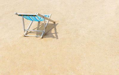 Empty deck chairs against bright sun