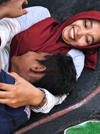 Smiling woman wearing hijab with son