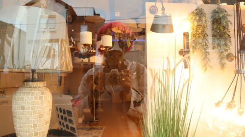 People standing by glass window of store