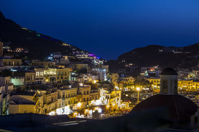 Illuminated cityscape against clear sky at night