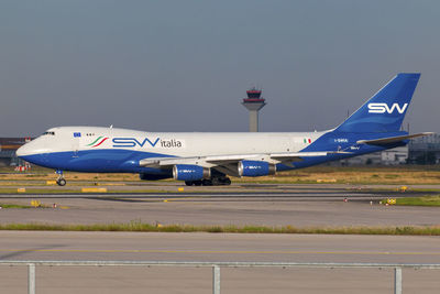 Airplane on runway against clear sky