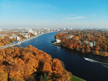 High angle view of river amidst city against sky