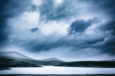 Scenic view of mountains and lake against sky