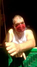 Midsection of man holding illuminated lighting equipment