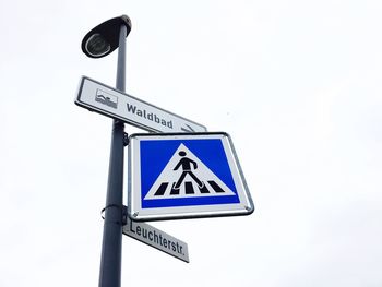 Low angle view of road sign against clear sky