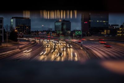 Light trails on road in city at night