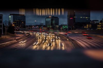 Light trails on road in city at night