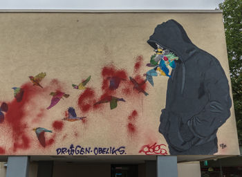 Side view of woman standing against wall