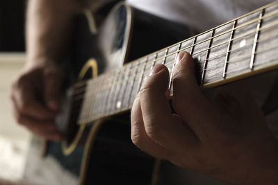 Cropped hand playing guitar