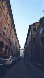 Street amidst buildings against sky in city