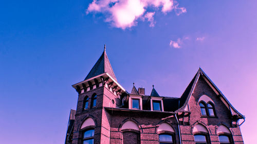 Low angle view of building against blue sky