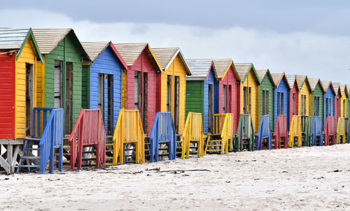 Colorful umbrellas on beach against sky