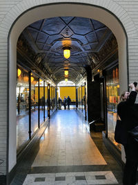 People walking in illuminated building