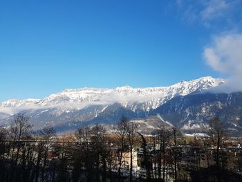 Scenic view of snowcapped mountains against blue sky