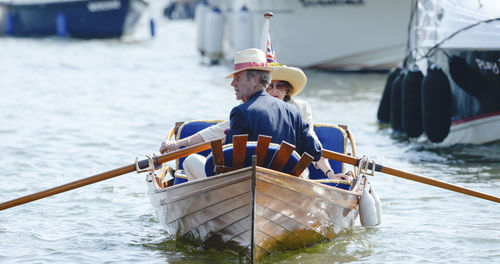 People sitting on boat sailing in sea