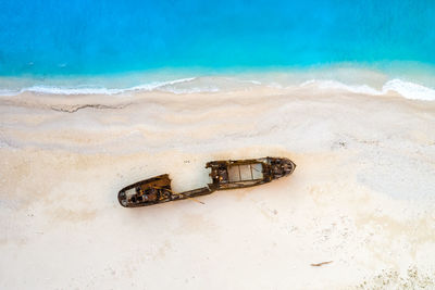 High angle view of abandoned container on beach