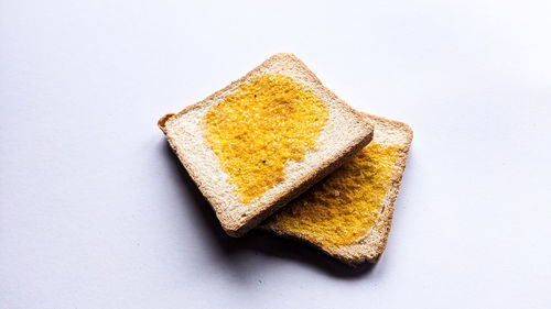 High angle view of bread against white background