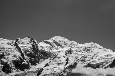 Scenic view of snowcapped mountains against clear sky