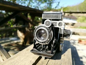 Close-up of camera on wooden table