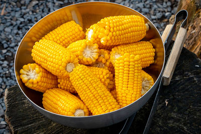 Corncob in a metal bowl ready to be used and heated on a barbecue