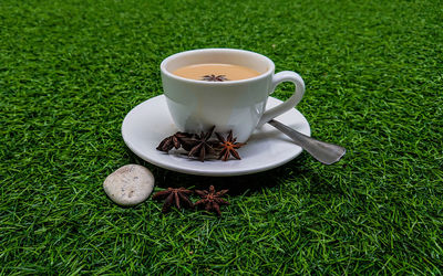 High angle view of coffee cup on grass