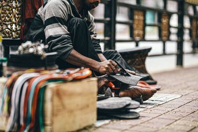 Midsection of man standing on street at market