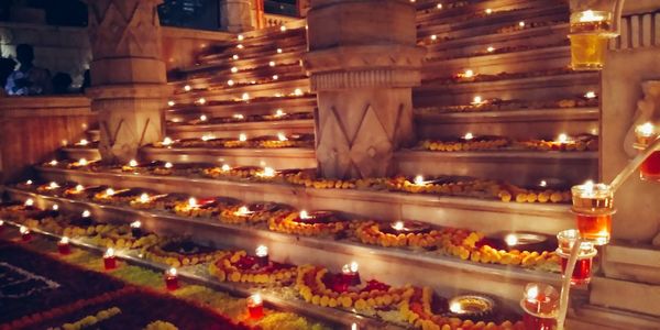 Illuminated candles in temple at night