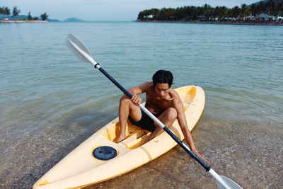 Man kayaking in lake