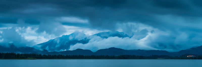 Scenic view of lake and mountains against sky