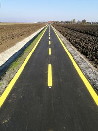 Empty road along countryside landscape