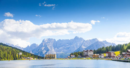 Residential district by lake against sky