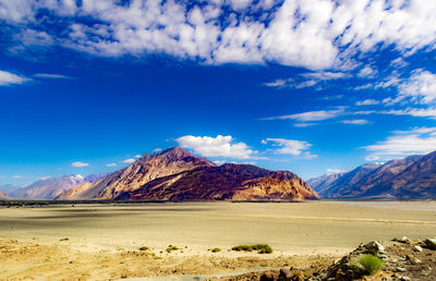 Scenic view of desert against blue sky