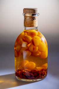 Close-up of orange juice in glass jar on table