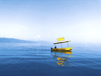 Scenic view of boat in sea against sky