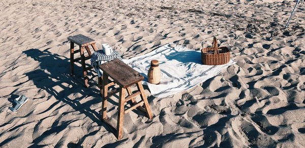 High angle view of empty chairs on beach