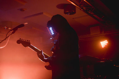 Low angle view of man playing guitar