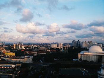 Cityscape against cloudy sky