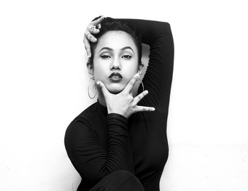 Portrait of young woman against white background