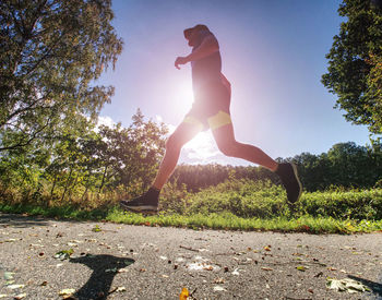Man running against clear sky on sunny day