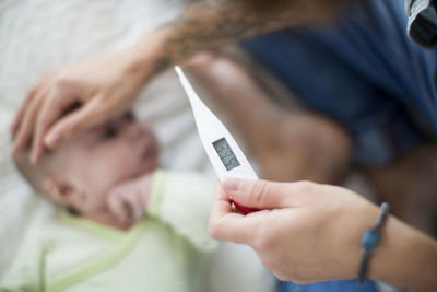 Mother checking babys temperature