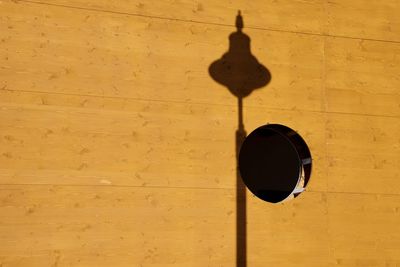 Low angle view of light hanging on wall