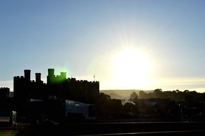 Silhouette buildings against sky during sunset