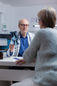 Doctor talking with patient in clinic