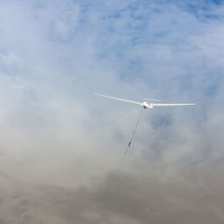 Low angle view of airplane flying in sky