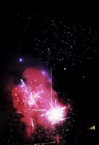 Low angle view of firework display at night