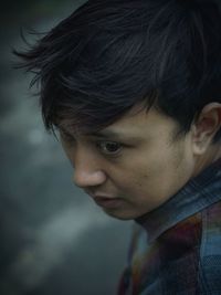 High angle view of thoughtful young man looking away